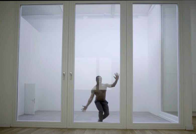 Man in a sealed glass room