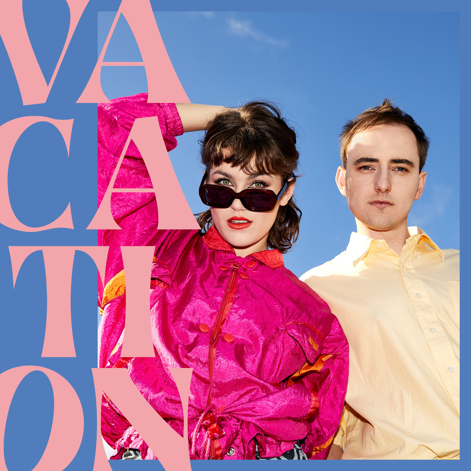 Man and woman in pink and beige clothing against light blue background with super imposed large pink text that reads "Vacations"