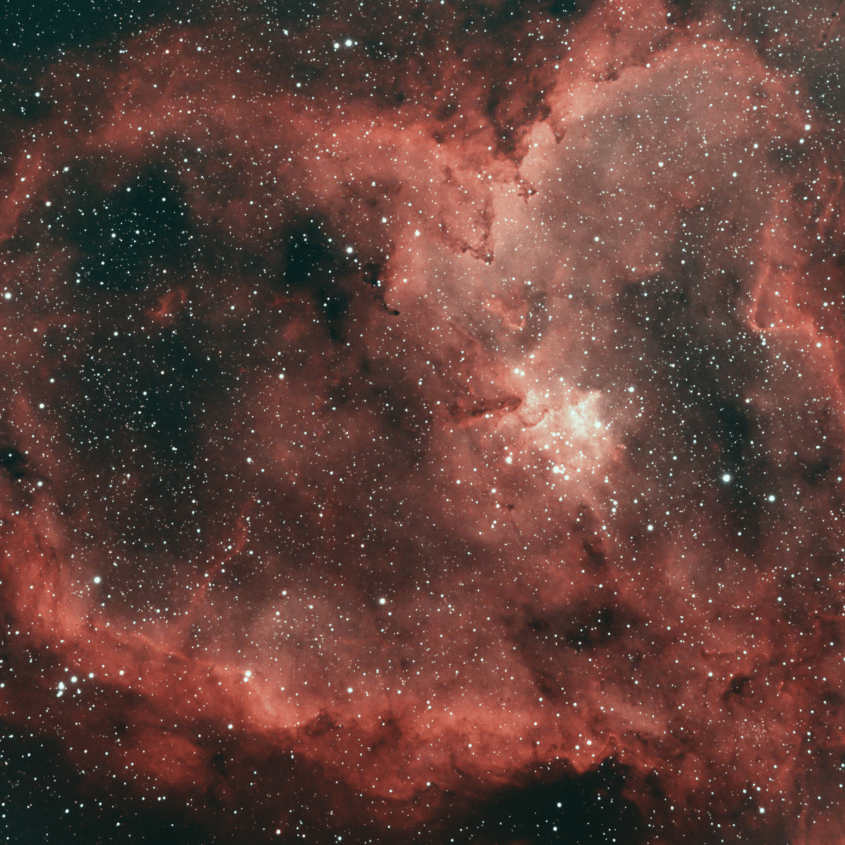 Image of a starry sky with a red-orange tint